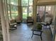Bright sunroom with multiple chairs providing comfortable seating, featuring a coffee table for relaxation at 10918 Sw 71St Cir, Ocala, FL 34476