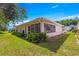 Exterior view of home showing manicured lawn and landscaping around the screened-in porch at 11058 Sw 69Th Cir, Ocala, FL 34476