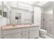 Bright bathroom with double vanity, updated lighting, and shower over tub combo offers functional style at 11058 Sw 69Th Cir, Ocala, FL 34476