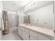 Bright bathroom features a shower-tub combo, large mirror, and vanity offering functionality and style at 11058 Sw 69Th Cir, Ocala, FL 34476