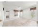 Spacious bedroom featuring neutral carpet, a ceiling fan, and large windows providing plenty of natural light at 11058 Sw 69Th Cir, Ocala, FL 34476
