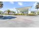 Stunning clubhouse featuring a covered entrance, beautiful landscaping, and ample parking at 11058 Sw 69Th Cir, Ocala, FL 34476