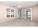 Enclosed carpeted lanai with ceiling fan and multiple windows, providing bright, flexible space for relaxing at 11058 Sw 69Th Cir, Ocala, FL 34476
