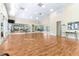 Large flex space with wood floors, mirrors, natural light, and vaulted ceilings at 11058 Sw 69Th Cir, Ocala, FL 34476