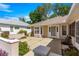 A clean, open courtyard at the front of the house with a well maintained exterior and lovely light at 11058 Sw 69Th Cir, Ocala, FL 34476