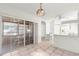 Open kitchen featuring white appliances, tile floors, and seamless transition to the sunroom at 11058 Sw 69Th Cir, Ocala, FL 34476