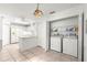 Kitchen featuring white cabinets and appliances, adjacent laundry area and tile floors at 11058 Sw 69Th Cir, Ocala, FL 34476