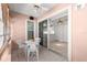 Enclosed patio with tiled floors, ceiling fan, and sliding door to kitchen, creating an inviting outdoor dining area at 11058 Sw 69Th Cir, Ocala, FL 34476
