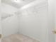 Walk-in closet with wire shelving offers efficient storage solutions for an organized wardrobe at 11058 Sw 69Th Cir, Ocala, FL 34476