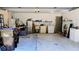 View of the home's cluttered garage featuring overhead lighting and room for laundry at 11591 Sw 78Th Ave, Ocala, FL 34476