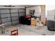 View of the home's garage featuring a gray door, overhead lighting, and plenty of room for storage at 11591 Sw 78Th Ave, Ocala, FL 34476
