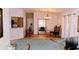 The living area featuring hardwood flooring, a tall mirror, chandelier, and a large accent rug at 11591 Sw 78Th Ave, Ocala, FL 34476