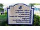 Sign displaying the locations of the Corporate Offices, Real Estate Office, Dog Park, and Orchid Club at 11591 Sw 78Th Ave, Ocala, FL 34476