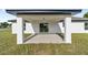 A covered back porch area with sliding glass doors leading into the home at 12 Bahia Pass Ter, Ocala, FL 34472