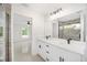 Elegant bathroom featuring a double vanity, a large mirror, and a view into the bedroom at 12 Bahia Pass Ter, Ocala, FL 34472