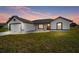 Charming single-story home with a well-maintained lawn and a welcoming red front door at 12 Bahia Pass Ter, Ocala, FL 34472