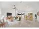 Open-concept living space with modern furnishings, a dining area, and a view of the kitchen at 12 Bahia Pass Ter, Ocala, FL 34472
