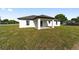 New home with a rear exterior and manicured lawn showing a backyard patio area at 12 Bahia Pass Ter, Ocala, FL 34472