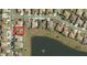 Aerial view of a residential neighborhood with a lake and the house highlighted in red at 13111 Se 86Th Cir, Summerfield, FL 34491