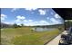 Expansive backyard with a scenic pond view from the enclosed patio at 13111 Se 86Th Cir, Summerfield, FL 34491