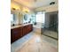 Bright bathroom featuring double sink vanity, garden tub, and glass door shower at 13111 Se 86Th Cir, Summerfield, FL 34491