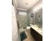 Well-lit bathroom featuring a glass shower, decorative backsplash, and neutral color palette at 13111 Se 86Th Cir, Summerfield, FL 34491