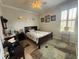 Cozy bedroom with a ceiling fan, large rug, and a window at 13111 Se 86Th Cir, Summerfield, FL 34491
