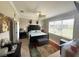 This bedroom offers a bed, ceiling fan, and a large window allowing lots of natural light at 13111 Se 86Th Cir, Summerfield, FL 34491