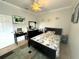 Cozy bedroom with a ceiling fan, large rug, and a window at 13111 Se 86Th Cir, Summerfield, FL 34491