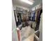 Walk-in closet with ample hanging space and shelving for organized storage of clothing and accessories at 13111 Se 86Th Cir, Summerfield, FL 34491
