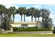 Del Webb's Spruce Creek Country Club community entrance sign with manicured landscaping and palm trees at 13111 Se 86Th Cir, Summerfield, FL 34491