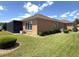 Back of house view showing the landscaped yard and screen porch at 13111 Se 86Th Cir, Summerfield, FL 34491
