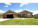 Charming single-story home featuring a stucco exterior, well-maintained lawn, and attached two-car garage at 13111 Se 86Th Cir, Summerfield, FL 34491
