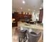 Kitchen boasts granite counters, stainless appliances, breakfast bar with seating, and ample dark wood cabinetry at 13111 Se 86Th Cir, Summerfield, FL 34491