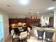 Spacious eat-in kitchen featuring granite countertops, stainless steel appliances, dark wood cabinetry, and breakfast bar at 13111 Se 86Th Cir, Summerfield, FL 34491