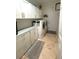 Bright laundry room with ample storage cabinets and counter space at 13111 Se 86Th Cir, Summerfield, FL 34491