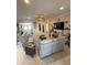 Open living area featuring tile floors, a ceiling fan, and a modern decor with neutral color palette at 13111 Se 86Th Cir, Summerfield, FL 34491