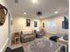 Cozy living room showcasing two sofas, tiled floor, a decorative rug, and ample natural light at 13111 Se 86Th Cir, Summerfield, FL 34491
