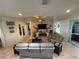 Stylish living room with tile flooring, media center, comfortable seating, and access to the backyard at 13111 Se 86Th Cir, Summerfield, FL 34491