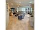 Spacious living room with neutral tones, comfortable seating, and large windows providing natural light at 13111 Se 86Th Cir, Summerfield, FL 34491