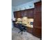 Home office features granite counters, cabinets, and neutral walls, offering workspace and storage solutions at 13111 Se 86Th Cir, Summerfield, FL 34491