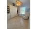 Neutral room featuring built in cabinets, Murphy bed, work space, and tile floors at 13111 Se 86Th Cir, Summerfield, FL 34491