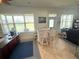 Bright sunroom with a bar area, tiled floors, and natural light streaming through the windows at 13111 Se 86Th Cir, Summerfield, FL 34491