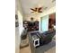 Comfortable sunroom featuring a leather chair, entertainment center, tiled floors, and access to the outdoors at 13111 Se 86Th Cir, Summerfield, FL 34491