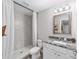 Bright bathroom featuring a granite countertop, modern vanity, and a tile shower at 13185 Sw 83Rd Terrace Rd, Ocala, FL 34473