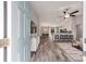 Bright, open-concept entryway revealing the dining and living area with sleek wood-look flooring and modern furnishings at 13185 Sw 83Rd Terrace Rd, Ocala, FL 34473