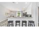Modern kitchen featuring granite countertops, breakfast bar with seating, and stainless steel appliances at 13185 Sw 83Rd Terrace Rd, Ocala, FL 34473