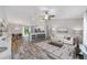 Open concept living room featuring neutral decor, a ceiling fan, with barstool seating at the kitchen counter at 13185 Sw 83Rd Terrace Rd, Ocala, FL 34473
