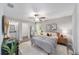 A calming main bedroom featuring neutral tones, a ceiling fan, and an ensuite bathroom at 13185 Sw 83Rd Terrace Rd, Ocala, FL 34473