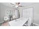 Office area features a ceiling fan, gray wood-look floors, and white decor at 13185 Sw 83Rd Terrace Rd, Ocala, FL 34473